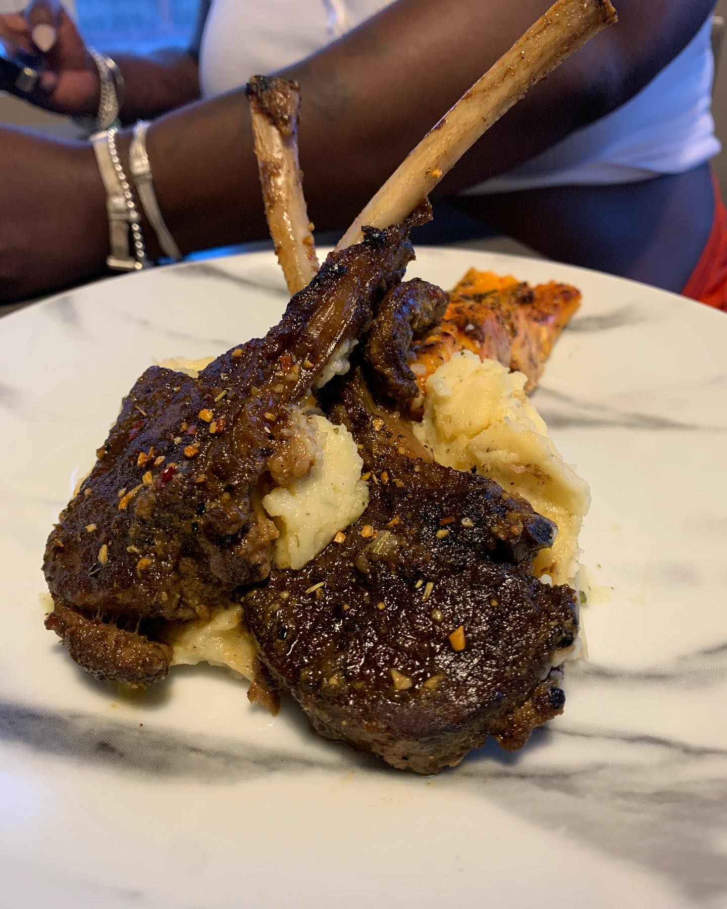 Seasoned lamb chops over mashed potatoes