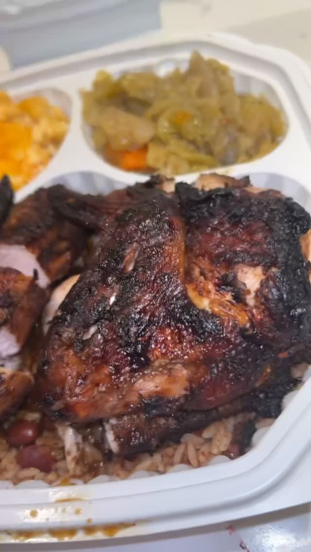 Jerk chicken over rice and peas with candied yams and steamed cabbage